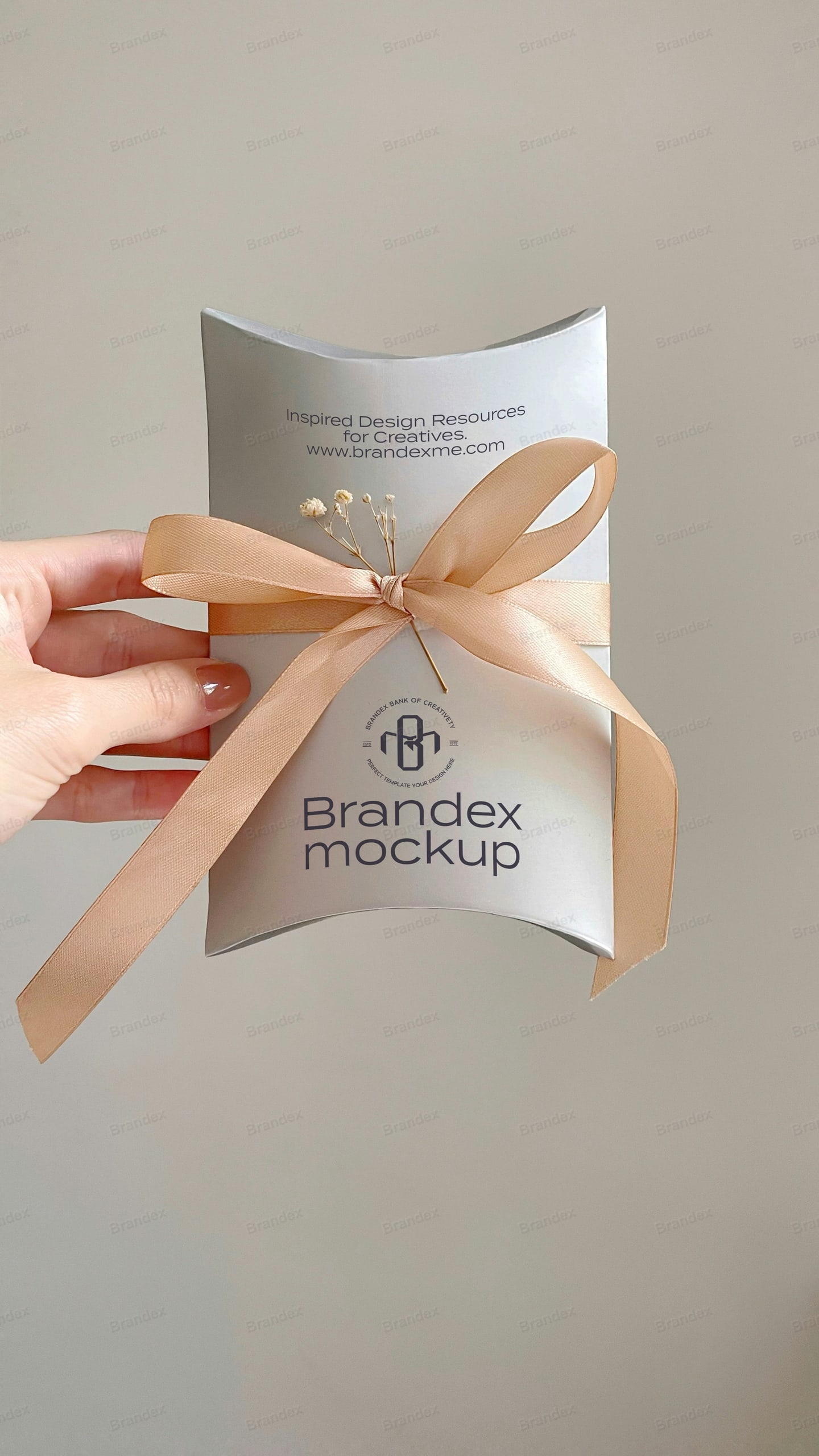 White Pillow Gift Box Mockup Held in Hand with Ribbon and Baby’s Breath