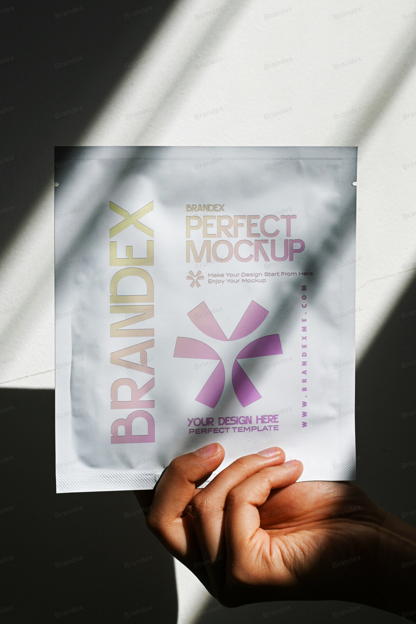 Holographic Foil Pouch Packaging Mockup Held in Hand with Sunlight Shadows